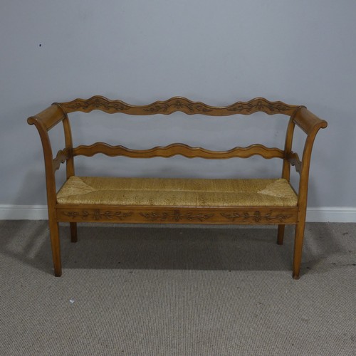 513 - A 20th century French oak and rush seat Bench/Sofa, with carved headrest and apron, flanked by scrol... 