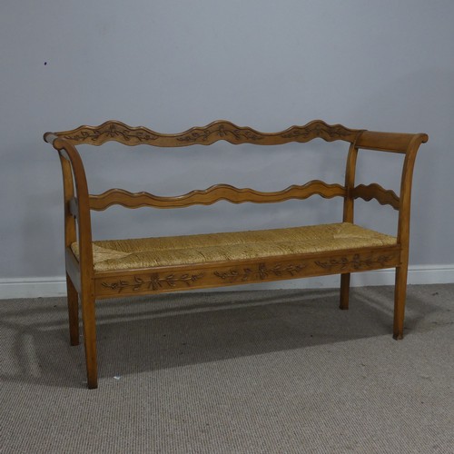 513 - A 20th century French oak and rush seat Bench/Sofa, with carved headrest and apron, flanked by scrol... 