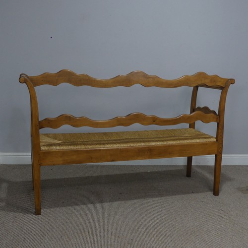 513 - A 20th century French oak and rush seat Bench/Sofa, with carved headrest and apron, flanked by scrol... 