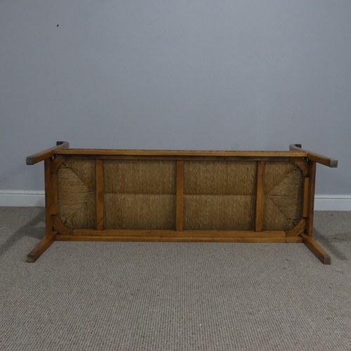 513 - A 20th century French oak and rush seat Bench/Sofa, with carved headrest and apron, flanked by scrol... 