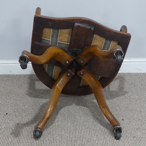 514 - An early 20th century Arts and Crafts style captains swivel desk Chair, shaped backrest and shaped s... 