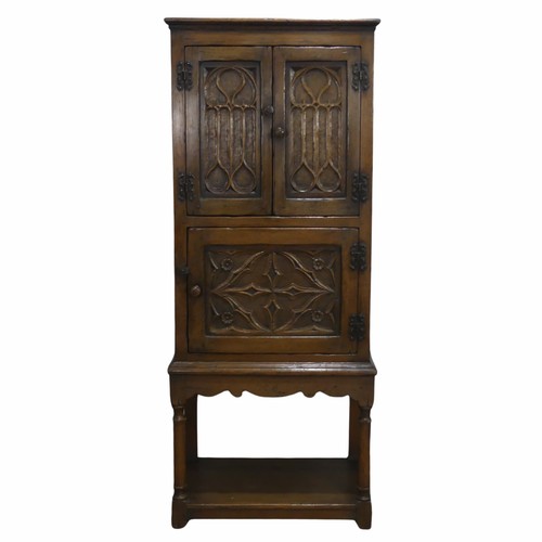 516 - A 20th century oak Art Nouveau inspired hall Cupboard, of small proportions, with panel doors, raise... 