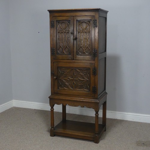 516 - A 20th century oak Art Nouveau inspired hall Cupboard, of small proportions, with panel doors, raise... 