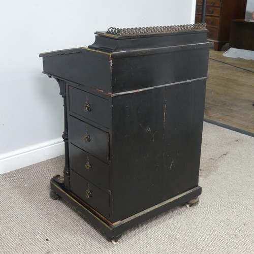 536 - An ebonised Victorian Davenport, the top with three quarter brass gallery and red painted writing su... 