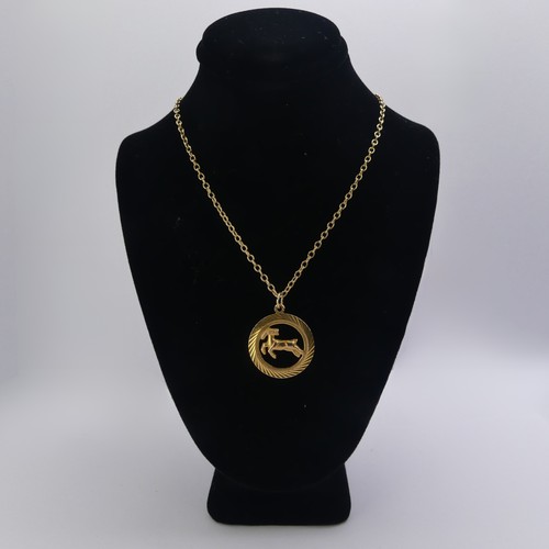 241 - A 9ct yellow gold 'Capricorn' Zodiac Pendant, 23.3mm diameter, on a 9ct gold oval link chain, 53cm l... 