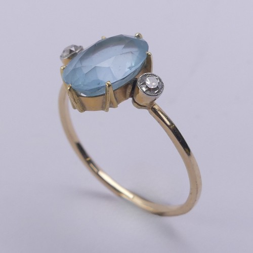 173 - An aquamarine and diamond Ring, the central oval facetted aquamarine approx. 10.8mm long, claw set w... 