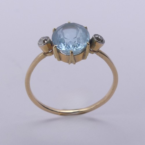 173 - An aquamarine and diamond Ring, the central oval facetted aquamarine approx. 10.8mm long, claw set w... 