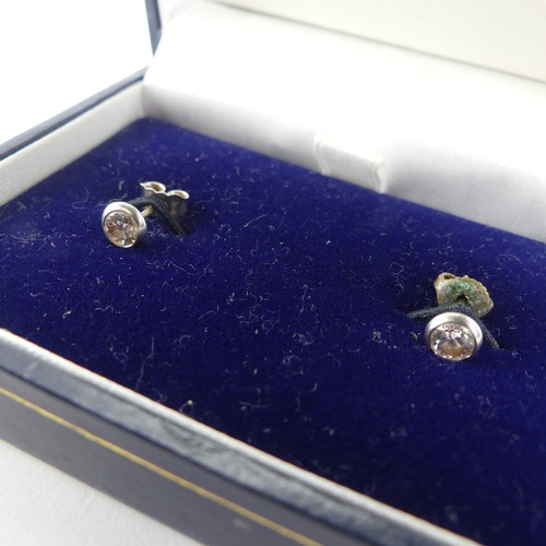 279 - A pair of diamond stud Earrings, the brilliant cut stones each approx. 0.25ct, collet set in 18ct wh... 