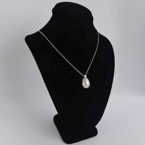 248 - A cultured pearl and diamond Pendant, the pear shaped pearl 14mm long, surmounted by a brilliant cut... 