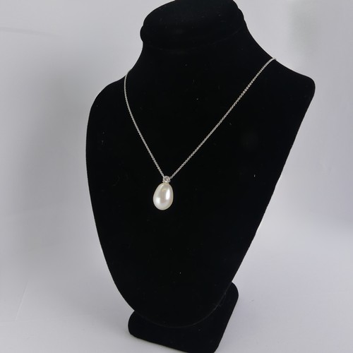 248 - A cultured pearl and diamond Pendant, the pear shaped pearl 14mm long, surmounted by a brilliant cut... 