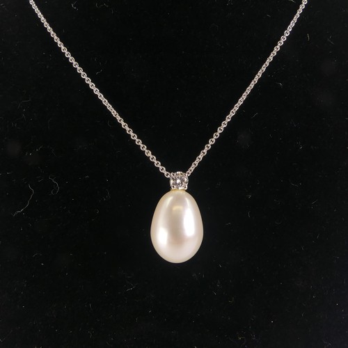 248 - A cultured pearl and diamond Pendant, the pear shaped pearl 14mm long, surmounted by a brilliant cut... 