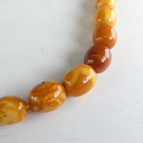 300 - A graduated amber bead Necklace, the largest 16mm long, on replacement string and paste clasp, toget... 