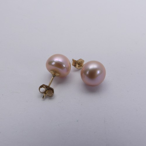 311 - A triple row of pink freshwater Pearls, with silver clasp, together with a pair of gold plate mounte... 