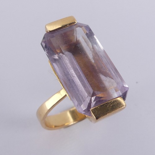 184 - An amethyst Dress Ring, the pale emerald cut stone mounted in 18ct yellow gold, with French marks, 2... 