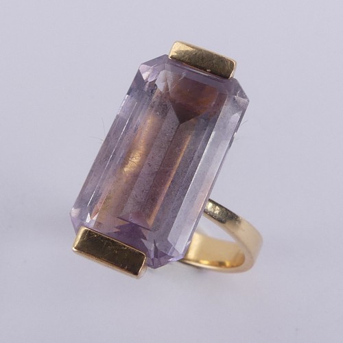 184 - An amethyst Dress Ring, the pale emerald cut stone mounted in 18ct yellow gold, with French marks, 2... 