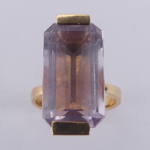 184 - An amethyst Dress Ring, the pale emerald cut stone mounted in 18ct yellow gold, with French marks, 2... 