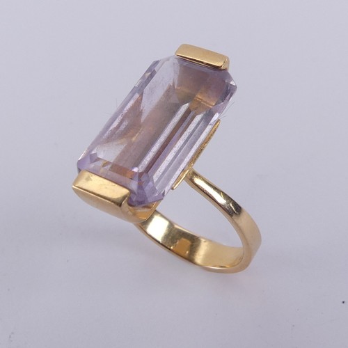 184 - An amethyst Dress Ring, the pale emerald cut stone mounted in 18ct yellow gold, with French marks, 2... 