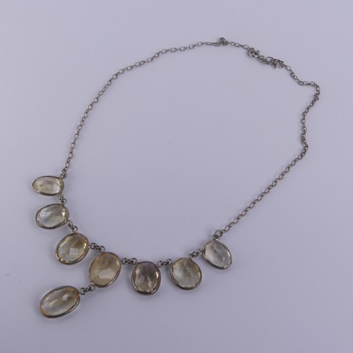 257 - A vintage citrine Necklace, the seven oval facetted stone with one further suspended below collet se... 