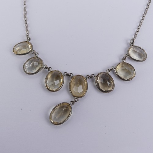 257 - A vintage citrine Necklace, the seven oval facetted stone with one further suspended below collet se... 