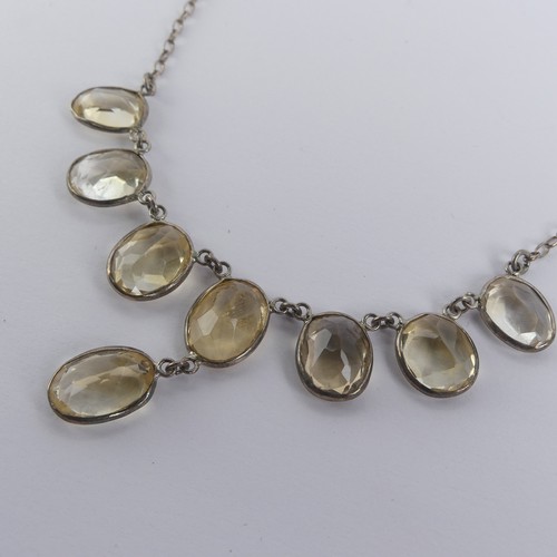 257 - A vintage citrine Necklace, the seven oval facetted stone with one further suspended below collet se... 