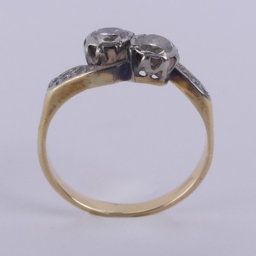 192 - A two stone diamond cross-over Ring, each circular stone approx. 0.2ct, with diamond point shoulders... 