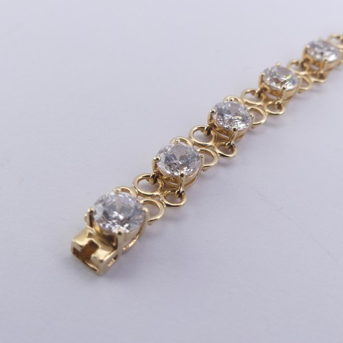 272 - A cubic zirconia Bracelet, the thirteen brilliant cut stones approx. 6mm diameter, claw set in 14ct ... 