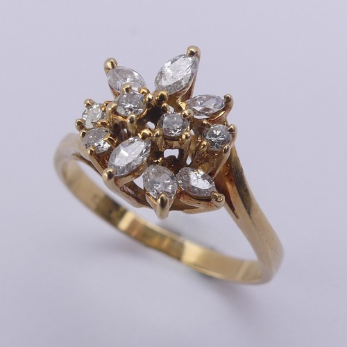 194 - A diamond cluster Ring, the navette and brilliant cut stones claw set in an abstract foliate design,... 