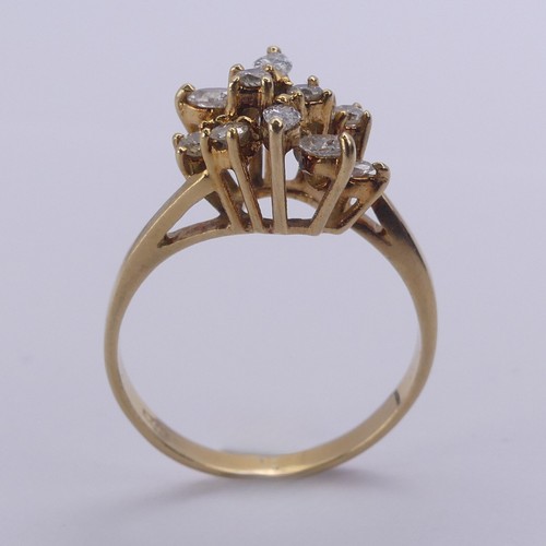 194 - A diamond cluster Ring, the navette and brilliant cut stones claw set in an abstract foliate design,... 