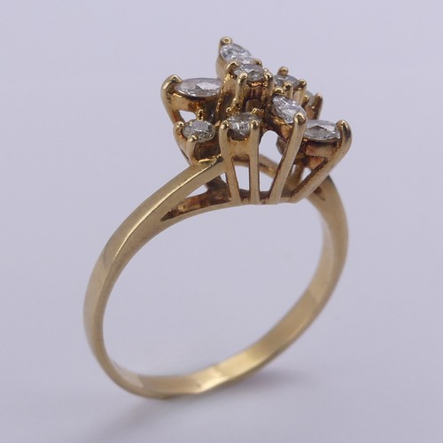 194 - A diamond cluster Ring, the navette and brilliant cut stones claw set in an abstract foliate design,... 