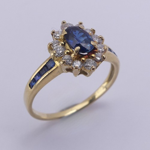 196 - A sapphire and diamond cluster Ring, the central oval facetted sapphire approx. 5.9mm long, within a... 