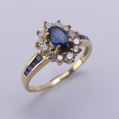 196 - A sapphire and diamond cluster Ring, the central oval facetted sapphire approx. 5.9mm long, within a... 