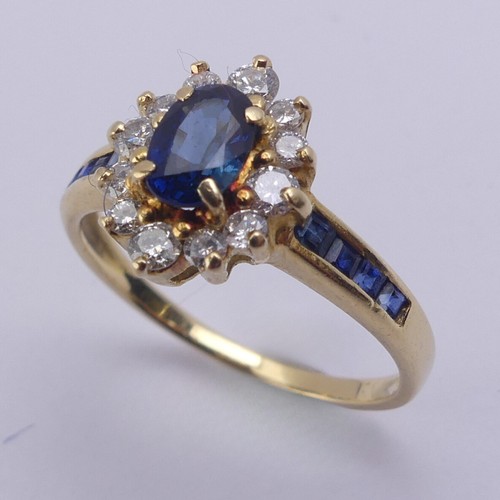 196 - A sapphire and diamond cluster Ring, the central oval facetted sapphire approx. 5.9mm long, within a... 