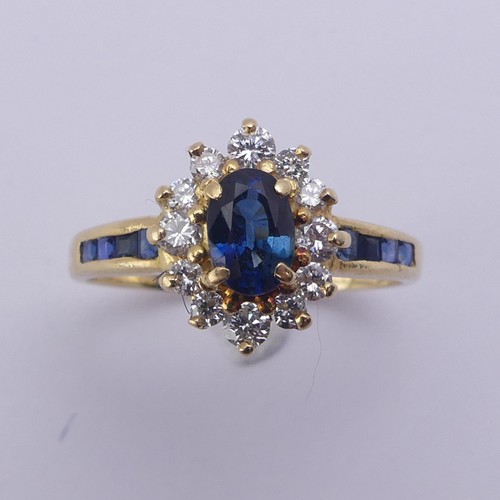 196 - A sapphire and diamond cluster Ring, the central oval facetted sapphire approx. 5.9mm long, within a... 