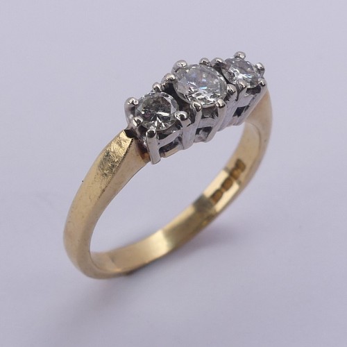 197 - A three stone diamond Ring, the brilliant cut stones claw set in 18ct yellow and white gold, approx.... 