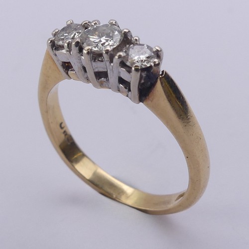 197 - A three stone diamond Ring, the brilliant cut stones claw set in 18ct yellow and white gold, approx.... 