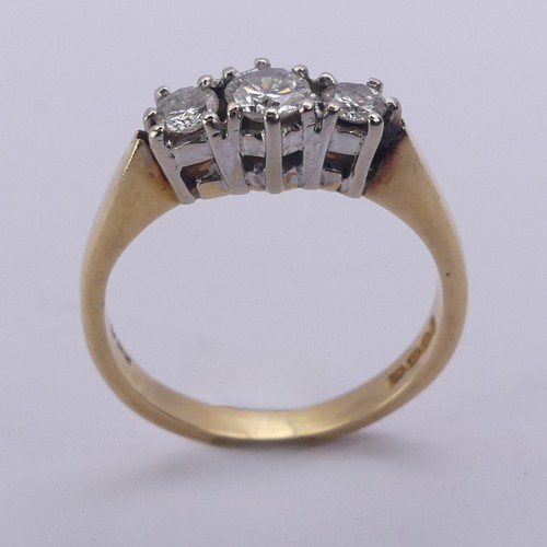 197 - A three stone diamond Ring, the brilliant cut stones claw set in 18ct yellow and white gold, approx.... 