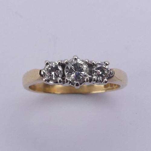 197 - A three stone diamond Ring, the brilliant cut stones claw set in 18ct yellow and white gold, approx.... 