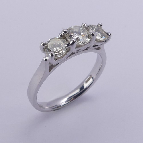 199 - A three stone diamond Ring, the brilliant cut stones claw set in 18ct white gold, total diamond weig... 