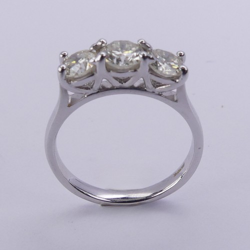 199 - A three stone diamond Ring, the brilliant cut stones claw set in 18ct white gold, total diamond weig... 