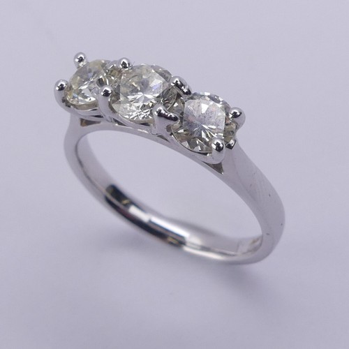 199 - A three stone diamond Ring, the brilliant cut stones claw set in 18ct white gold, total diamond weig... 