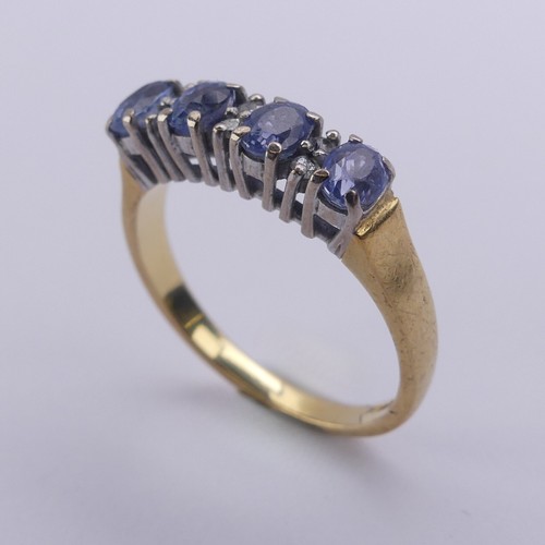 201 - A sapphire and diamond Ring, the four oval facetted cornflower blue sapphires approx. 4.2mm long, cl... 