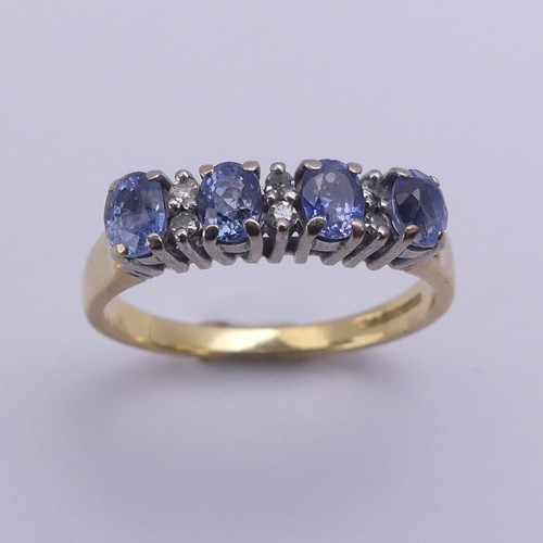 201 - A sapphire and diamond Ring, the four oval facetted cornflower blue sapphires approx. 4.2mm long, cl... 