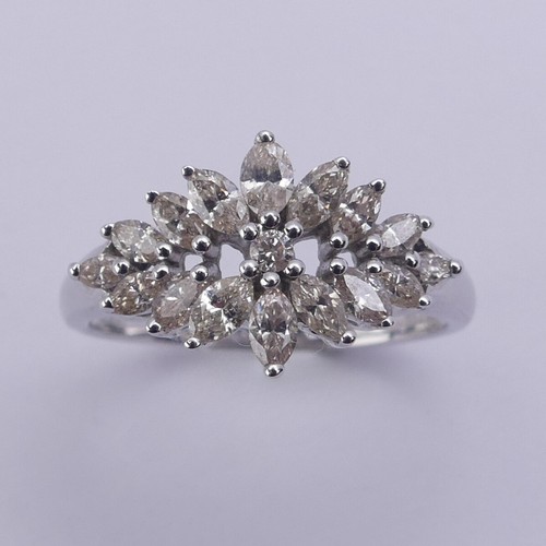 204 - A foliate diamond dress Ring, with graduated navette shaped stones around a small central brilliant ... 