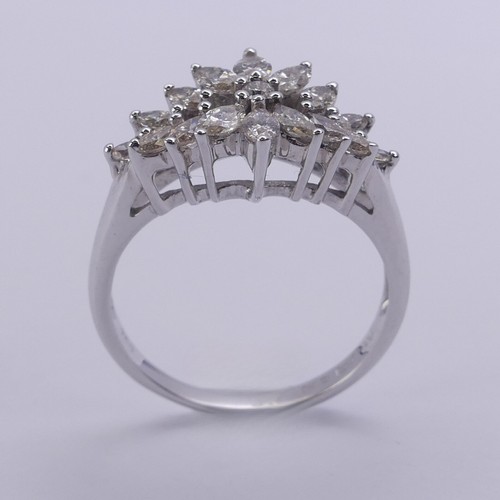 204 - A foliate diamond dress Ring, with graduated navette shaped stones around a small central brilliant ... 