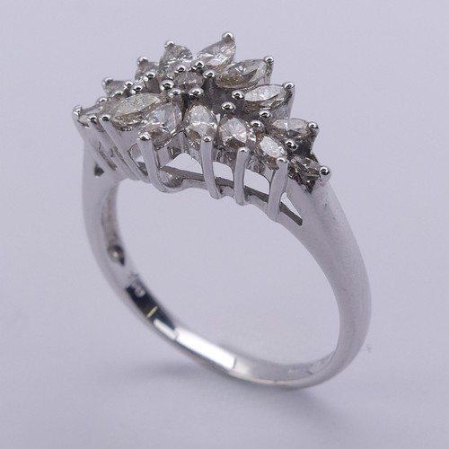 204 - A foliate diamond dress Ring, with graduated navette shaped stones around a small central brilliant ... 