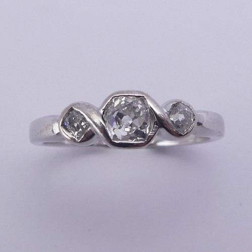 208 - A three stone diamond Ring, the centre stone approx. 0.25ct with a smaller stone on either side, all... 