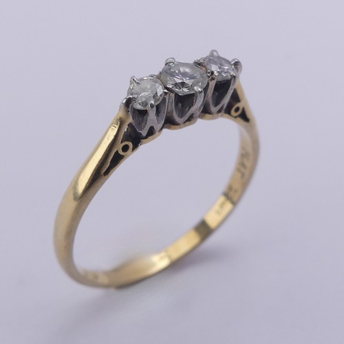 215 - A small three stone diamond Ring, approx. total diamond weight 0.24ct, mounted in 18ct yellow gold a... 