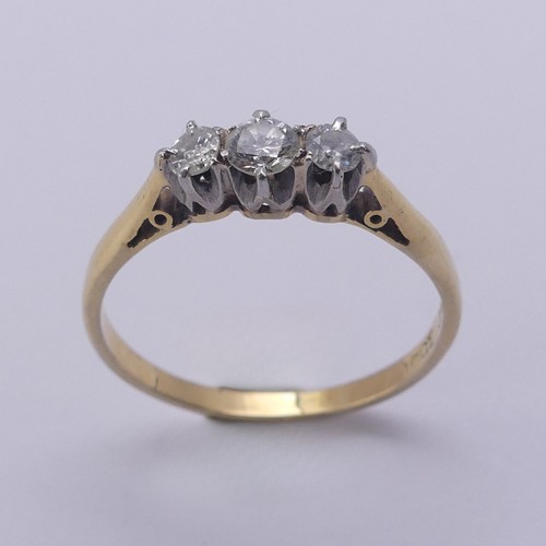 215 - A small three stone diamond Ring, approx. total diamond weight 0.24ct, mounted in 18ct yellow gold a... 