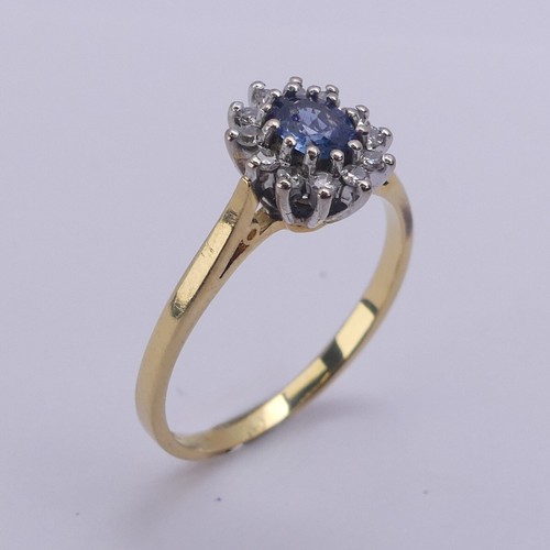 216 - A sapphire and diamond cluster Ring, the oval cluster 9.5mm long, all mounted in 18ct yellow and whi... 