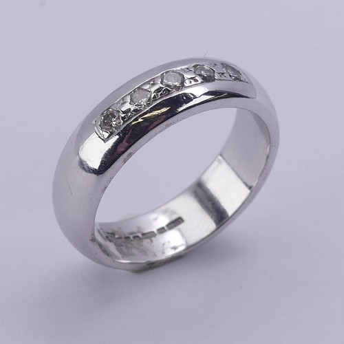 219 - A 9ct white gold Band, the front channel set with five small brilliant cut diamonds, 4.8mm wide, Siz... 